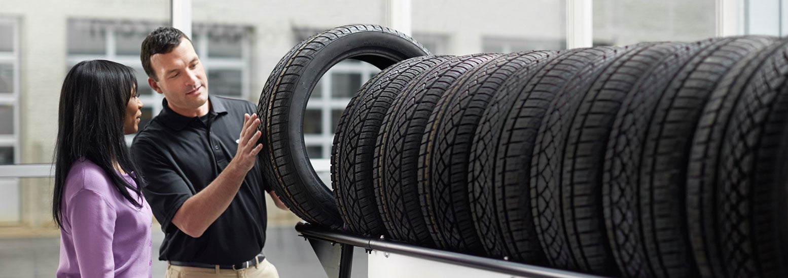 Subaru service representative showing customer a tire. | Bergstrom Subaru Oshkosh in Oshkosh WI