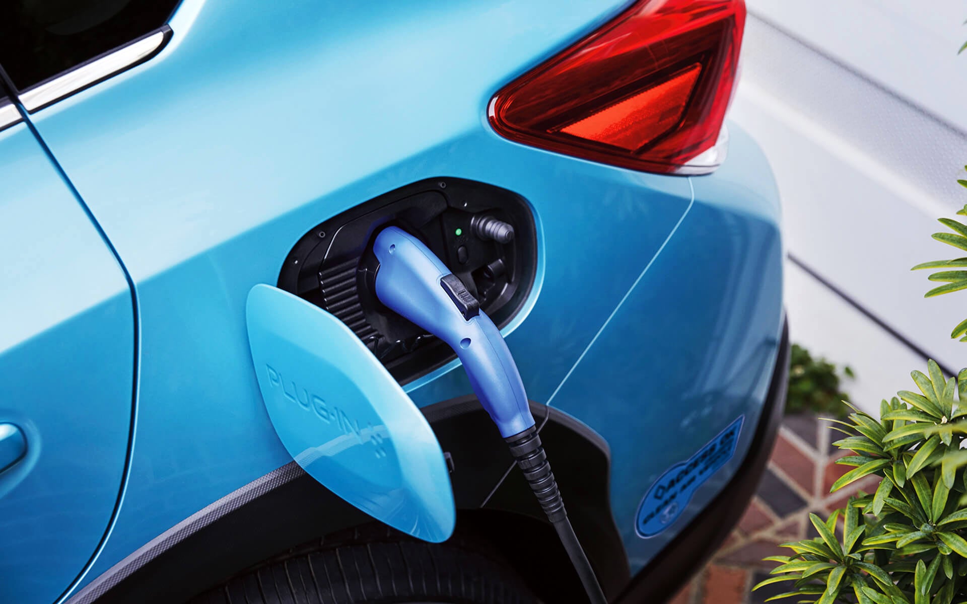 A close-up of the Subaru Crosstrek Hybrid's charging port with charging cable plugged in | Bergstrom Subaru Oshkosh in Oshkosh WI